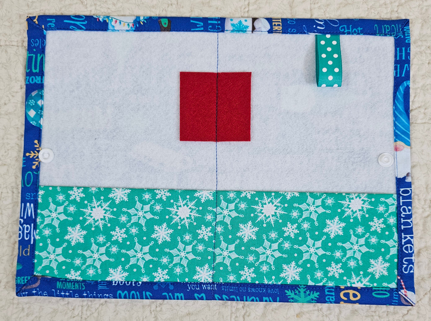 Winter Words on Blue Fabric with green snow flake pockets Thread Keeper