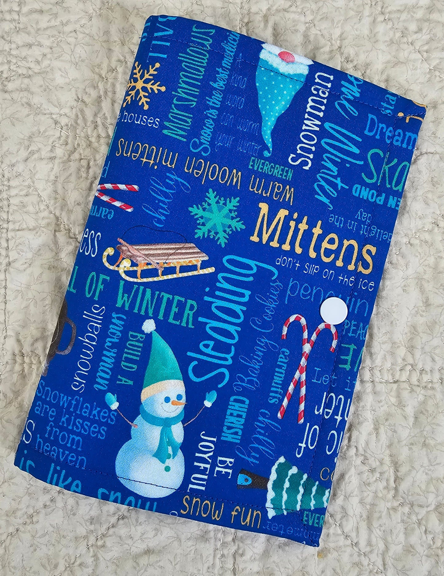 Winter Words on Blue Fabric with green snow flake pockets Thread Keeper