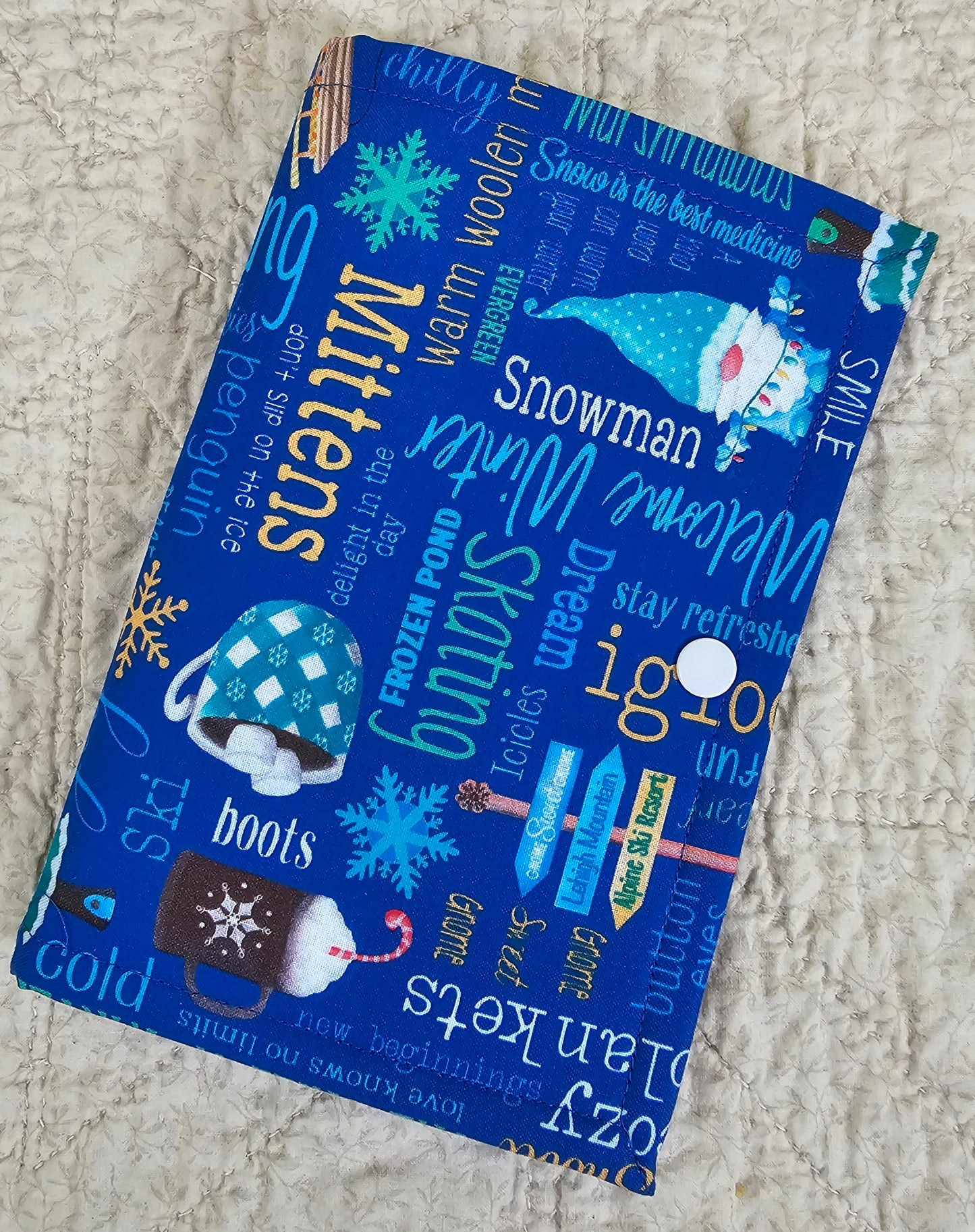 Winter Words on Blue Fabric with red snow flake pockets Thread Keeper